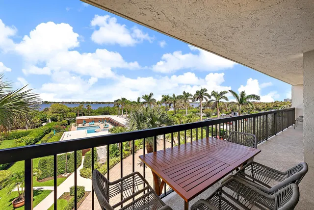 a view of a balcony with wooden benches