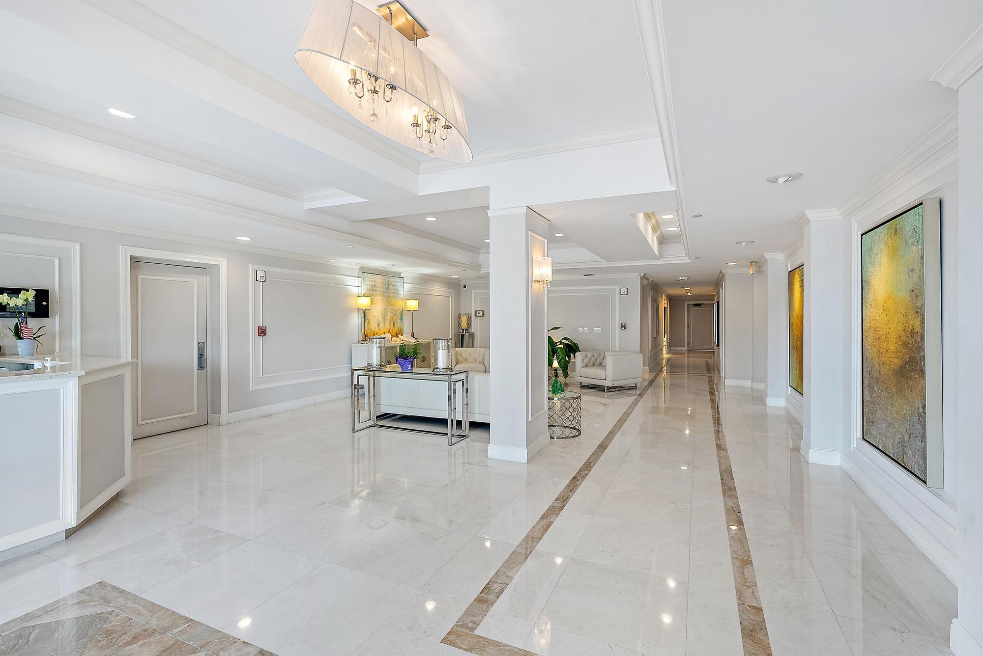 3390 South Ocean Boulevard, Unit 301 Palm Beach, FL 33480 - Photo 33 of 46 a lobby with furniture and a chandelier