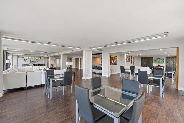 a view of a dining room with furniture wooden floor and chandelier