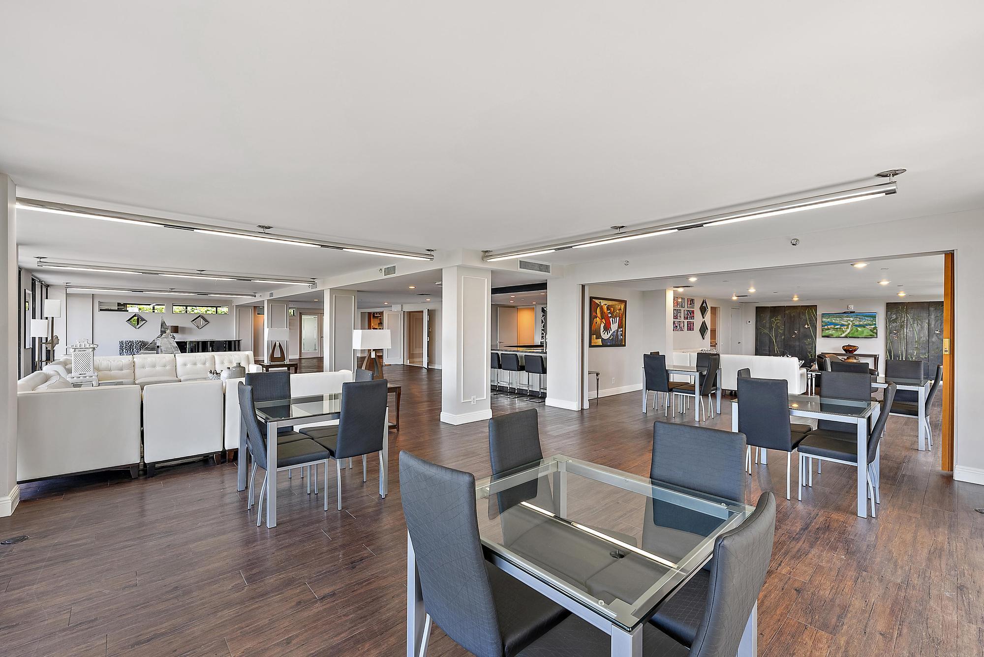 3390 South Ocean Boulevard, Unit 301 Palm Beach, FL 33480 - Photo 36 of 46 a view of a dining room with furniture wooden floor and chandelier