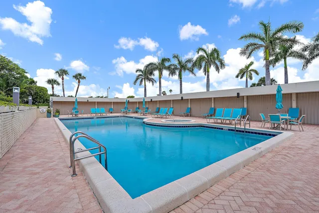 a view of swimming pool with outdoor seating and a potted plants