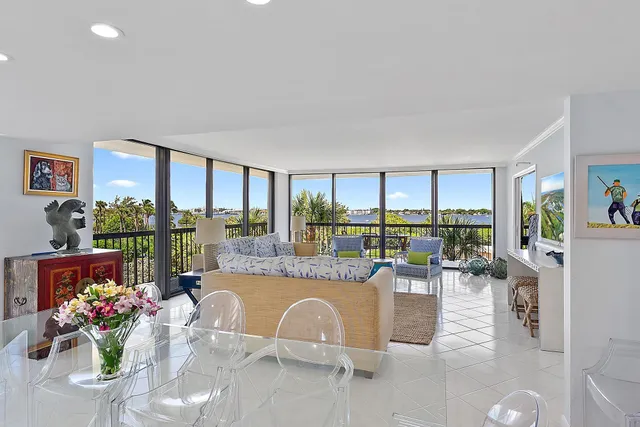 a dining hall with furniture and a large window