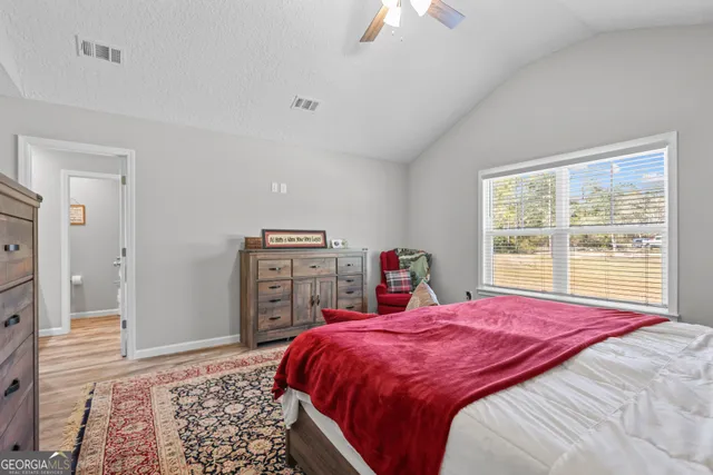 a bed sitting in a bedroom next to a window with a dresser