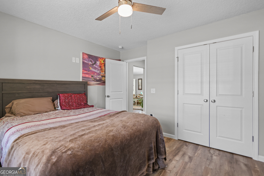 192 Hummingbird Lane Jesup, GA 31545 - Photo 18 of 26 a bedroom with a large bed and a chandelier