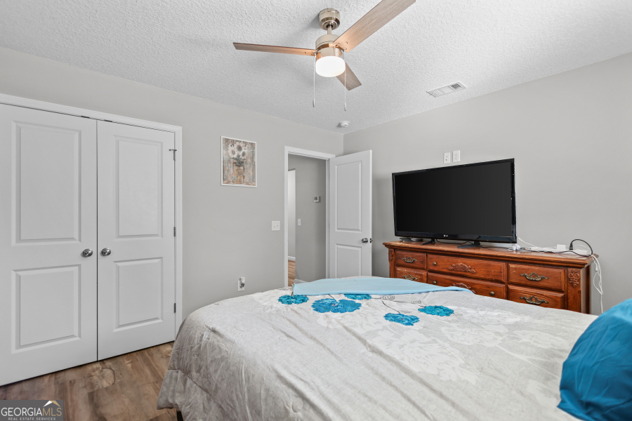 192 Hummingbird Lane Jesup, GA 31545 - Photo 19 of 26 a bedroom with a bed and a flat screen tv