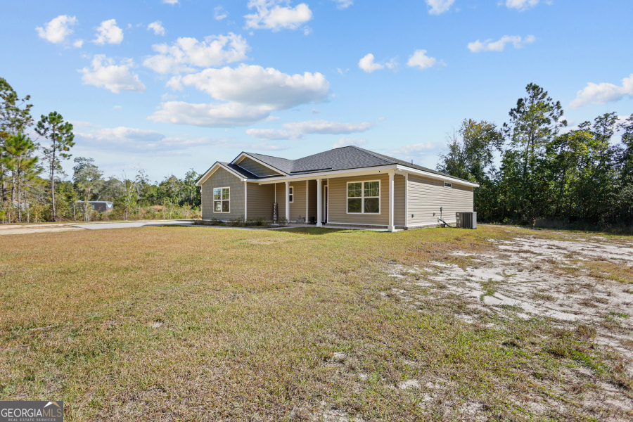 192 Hummingbird Lane Jesup, GA 31545 - Photo 2 of 26 a front view of a house with a garden