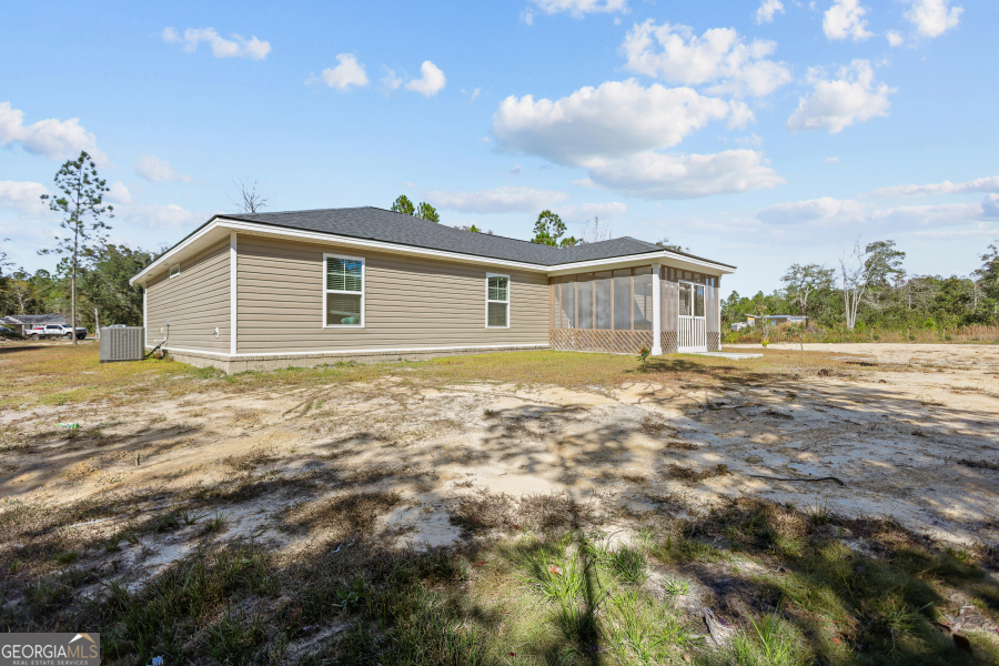 192 Hummingbird Lane Jesup, GA 31545 - Photo 23 of 26 a front view of a house with a yard