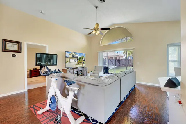 a living room with furniture and a chandelier