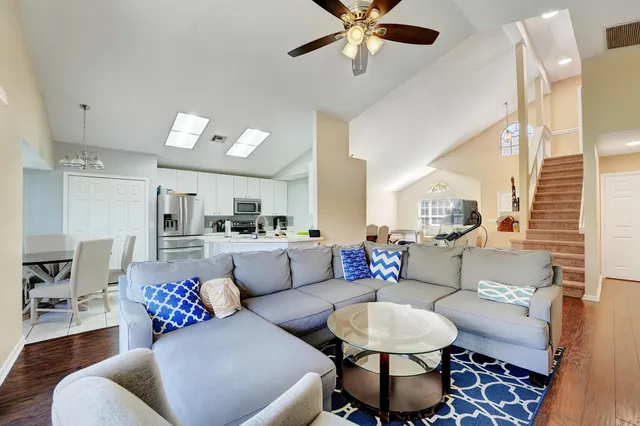 a living room with furniture and a chandelier