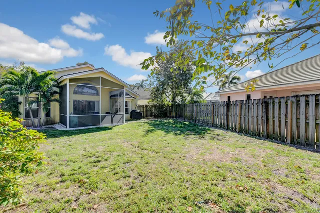a backyard of a house with wooden fence