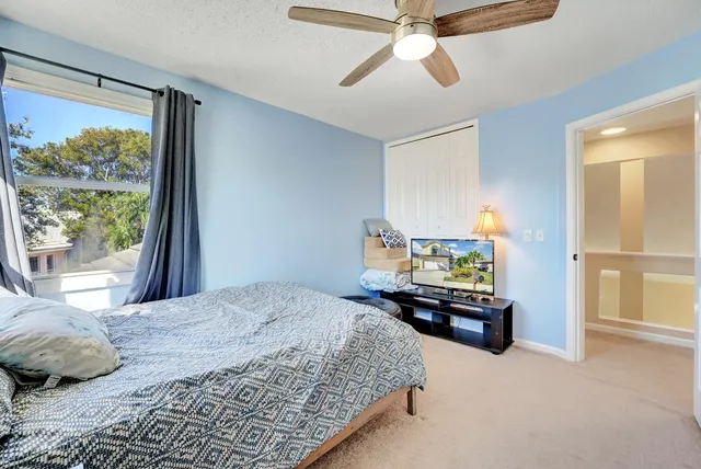 a bedroom with a bed and a large window