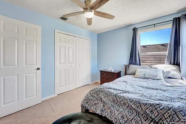 a bedroom with a large bed and a chandelier