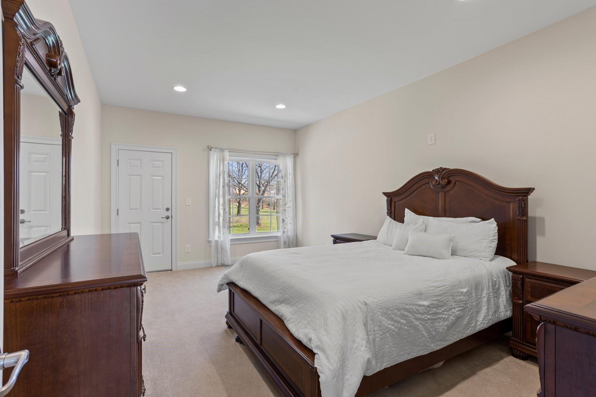 15020 Ranson Road, Unit B Huntersville, NC 28078 - Photo 33 of 40 a bedroom with a bed and a potted plant on dresser