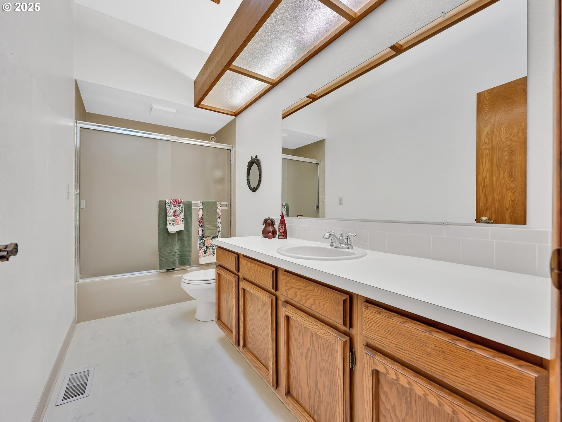 3239 Southwest 26th Street Gresham, OR 97080 - Photo 26 of 47 a bathroom with a sink a mirror and a bathtub