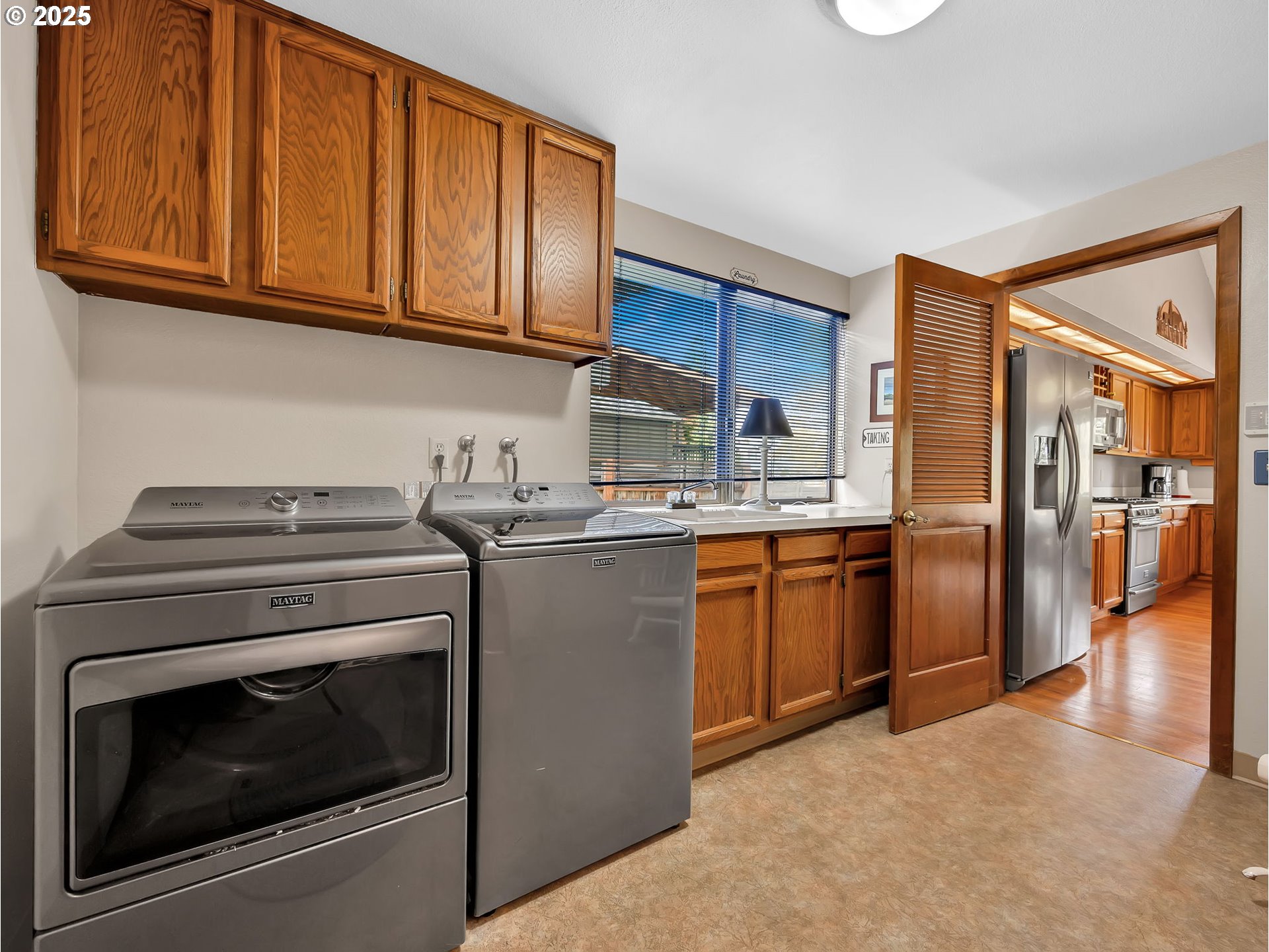 3239 Southwest 26th Street Gresham, OR 97080 - Photo 32 of 47 a kitchen with stainless steel appliances granite countertop a stove microwave and refrigerator