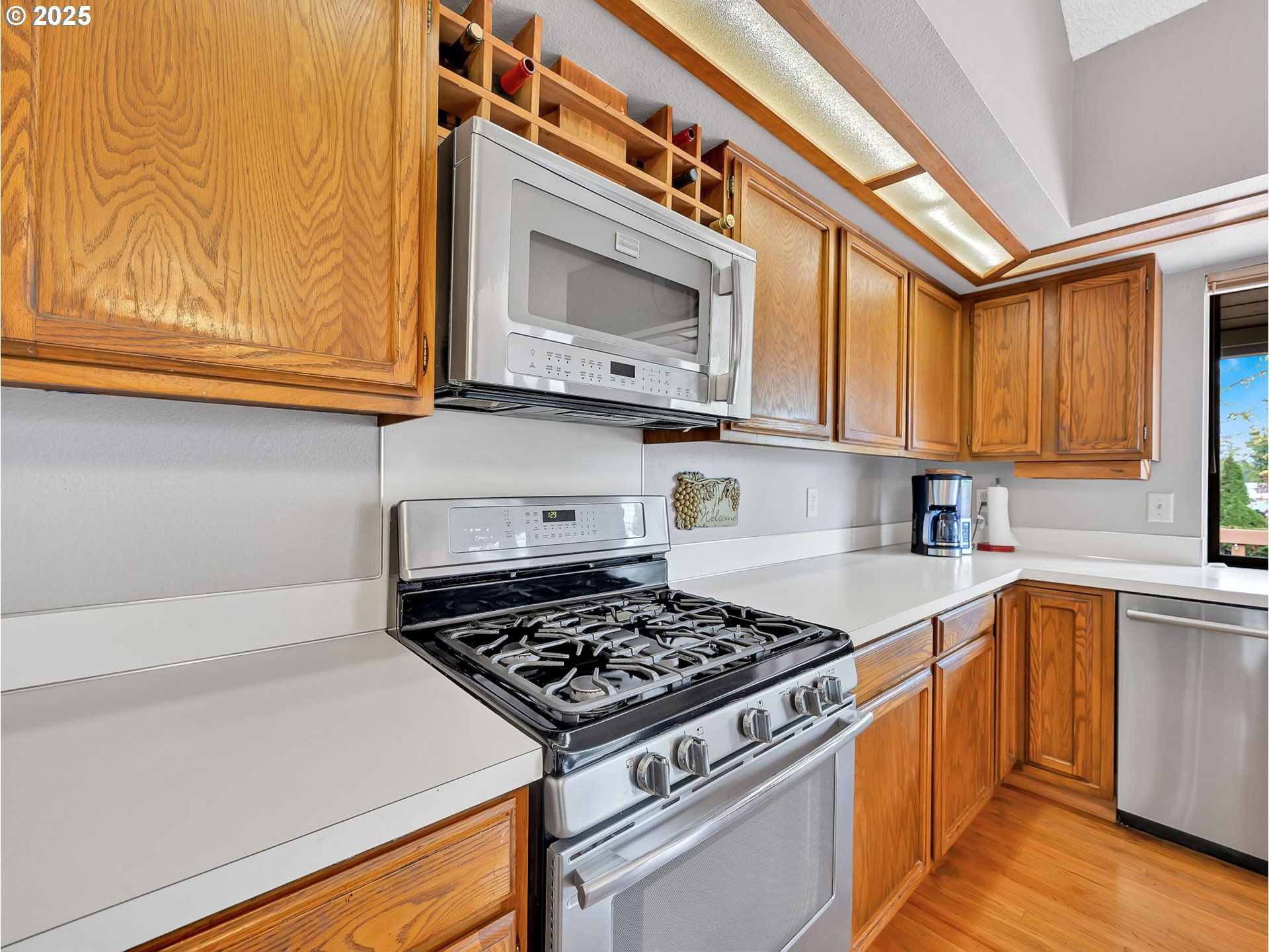 3239 Southwest 26th Street Gresham, OR 97080 - Photo 10 of 47 a kitchen with stainless steel appliances granite countertop a stove and a microwave