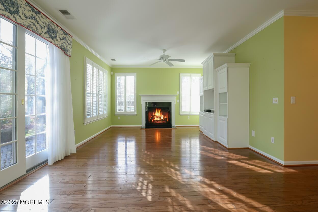 44 Portland Street Barnegat, NJ 08005 - Photo 9 of 47 a view of a livingroom with wooden floor a fireplace and window