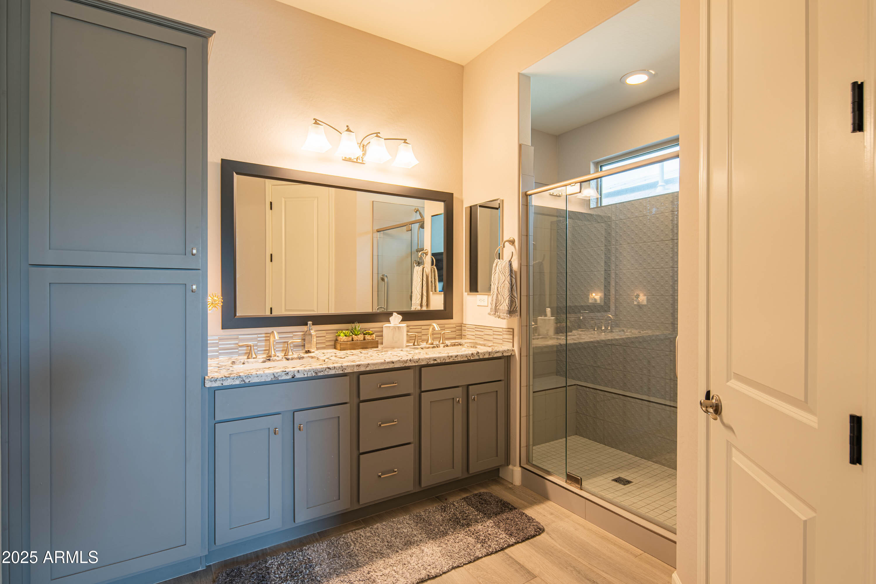 13189 West Caleb Road Peoria, AZ 85383 - Photo 36 of 70 a bathroom with a double vanity sink mirror and shower
