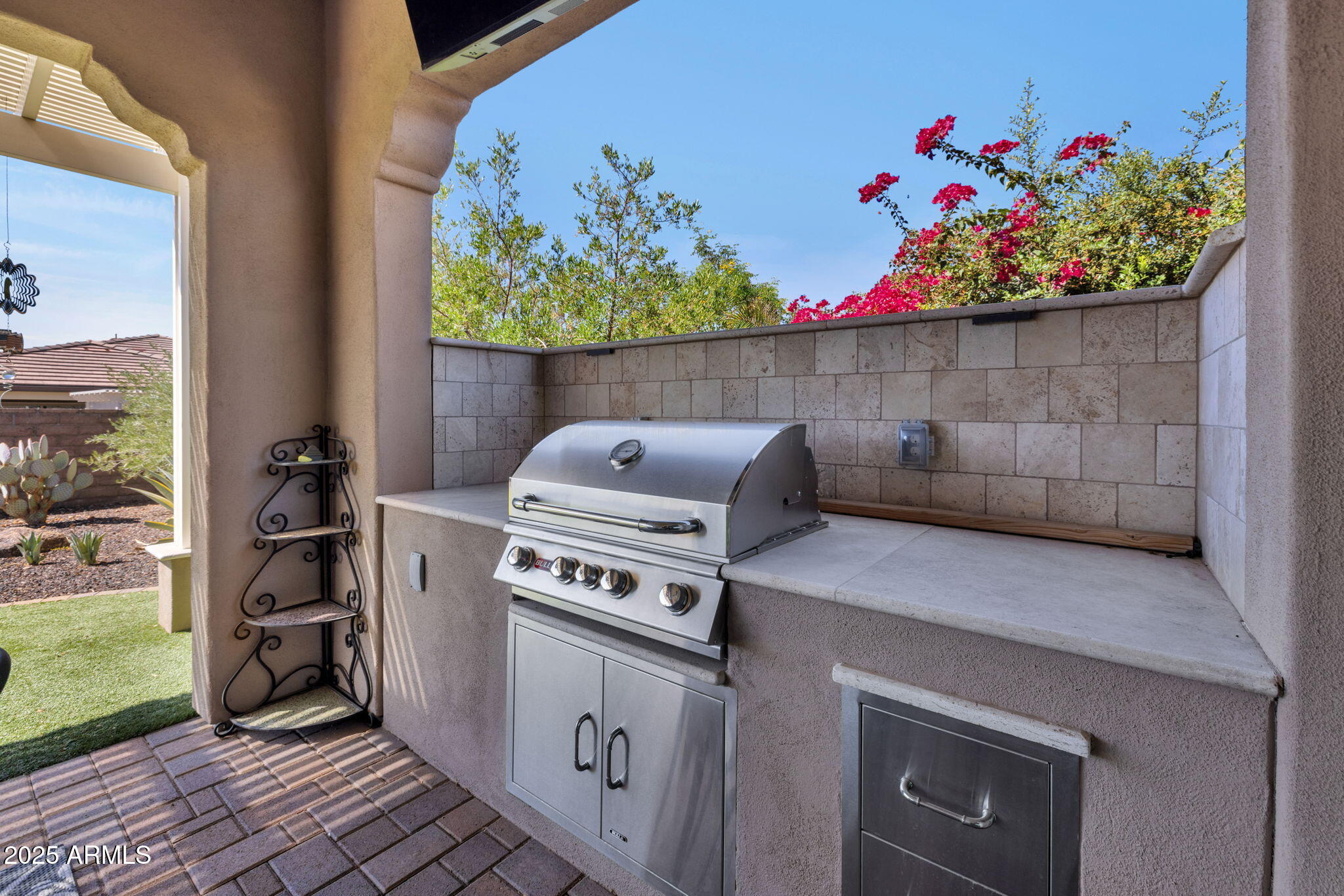 13189 West Caleb Road Peoria, AZ 85383 - Photo 51 of 70 a kitchen stove top oven and a table with wooden floor