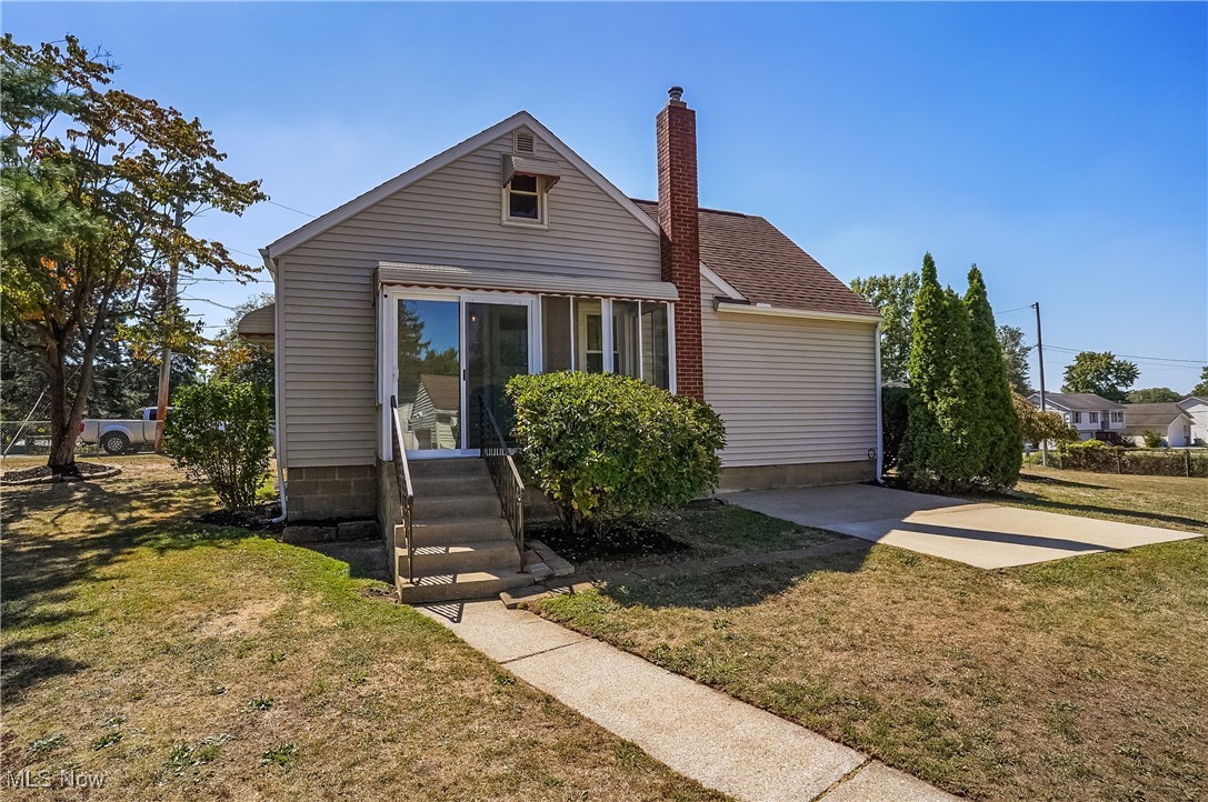 2809 McElwain Road Akron, OH 44312 - Photo 7 of 38 Cape cod featuring a back lawn, a chimney, and a shingled roof