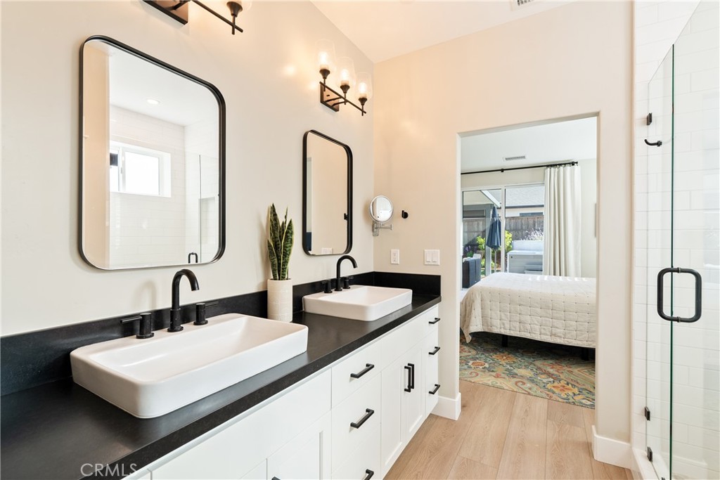 8550 El Corte Road Atascadero, CA 93422 - Photo 28 of 72 a bathroom with double vanity sinks and a mirror