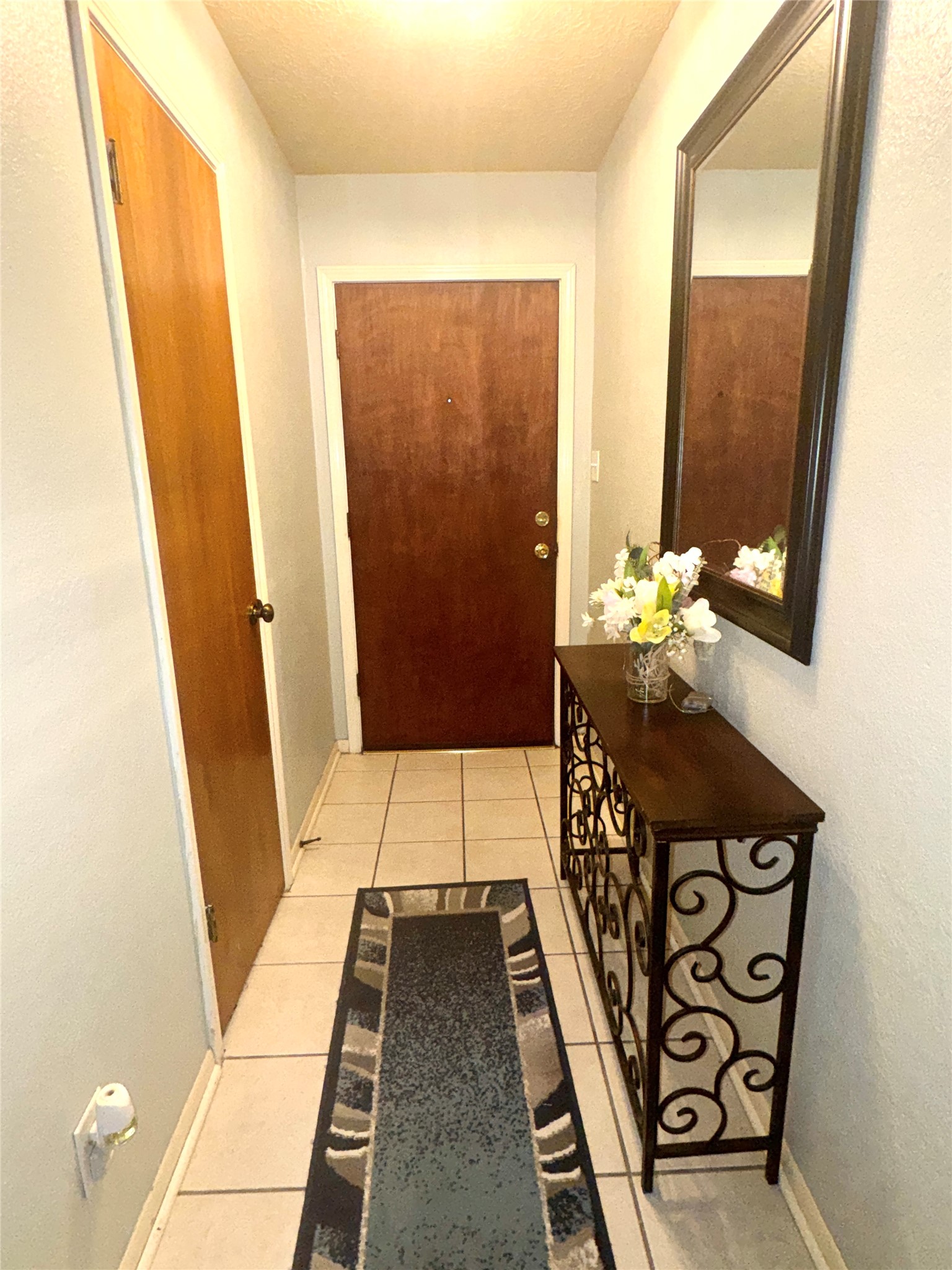 254 Evanston Street Houston, TX 77015 - Photo 11 of 22 a hallway with painting on the wall and a large mirror