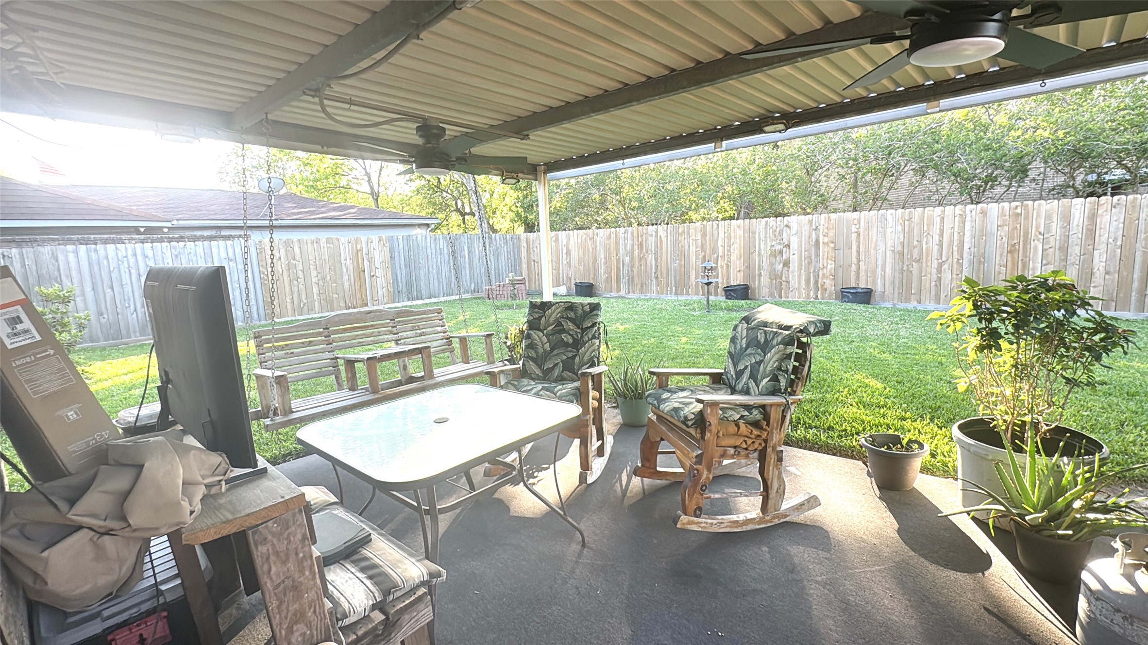 254 Evanston Street Houston, TX 77015 - Photo 21 of 22 a view of a patio with a table chairs and a backyard