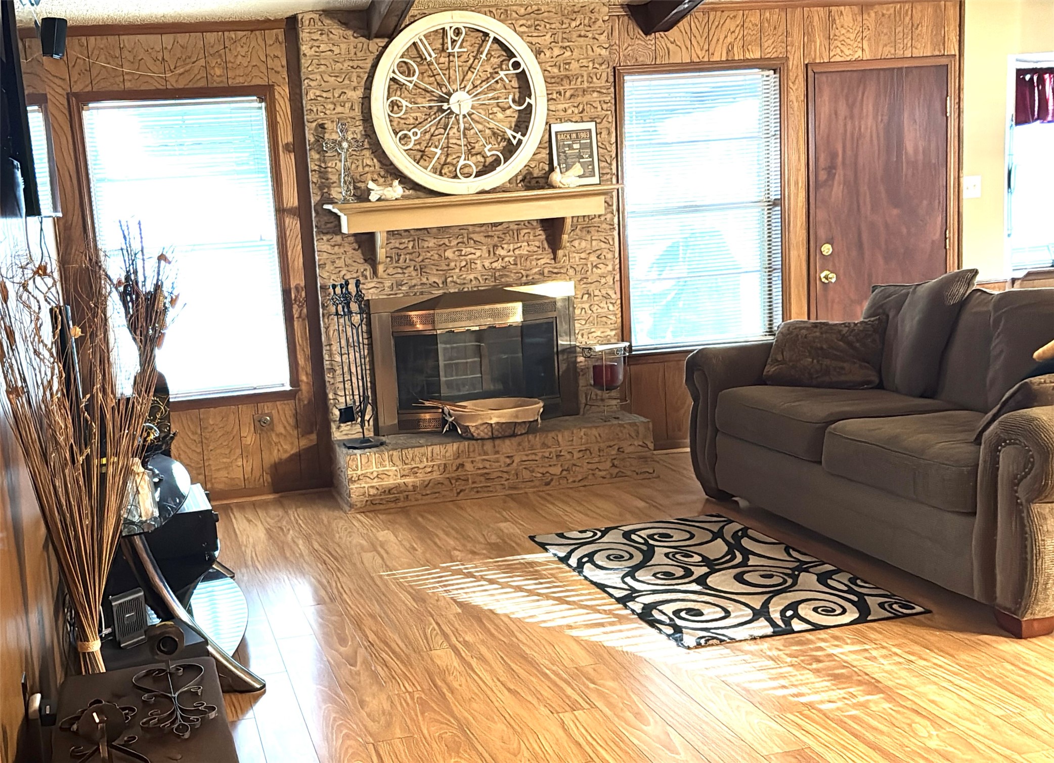 254 Evanston Street Houston, TX 77015 - Photo 5 of 22 a living room with a couch a fireplace a flat screen tv and a large window