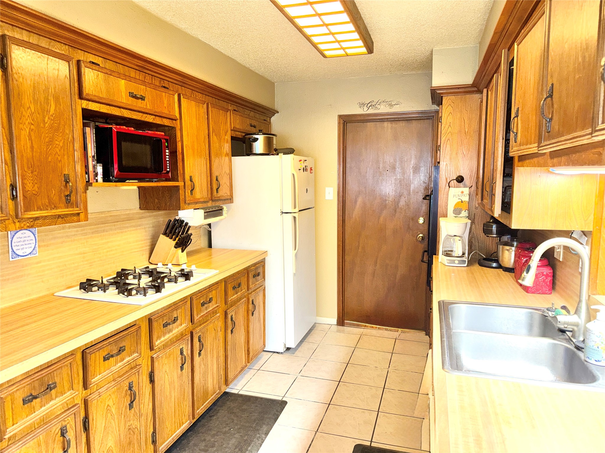254 Evanston Street Houston, TX 77015 - Photo 7 of 22 a kitchen with stainless steel appliances granite countertop a sink stove and refrigerator