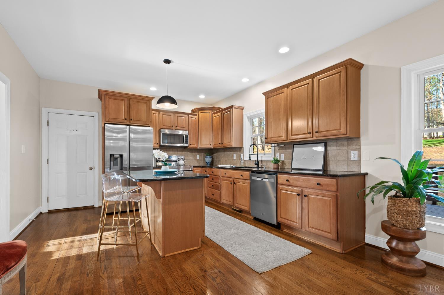 1089 Howards Scenic Trail Forest, VA 24551 - Photo 16 of 96 a kitchen with granite countertop wooden floors and stainless steel appliances