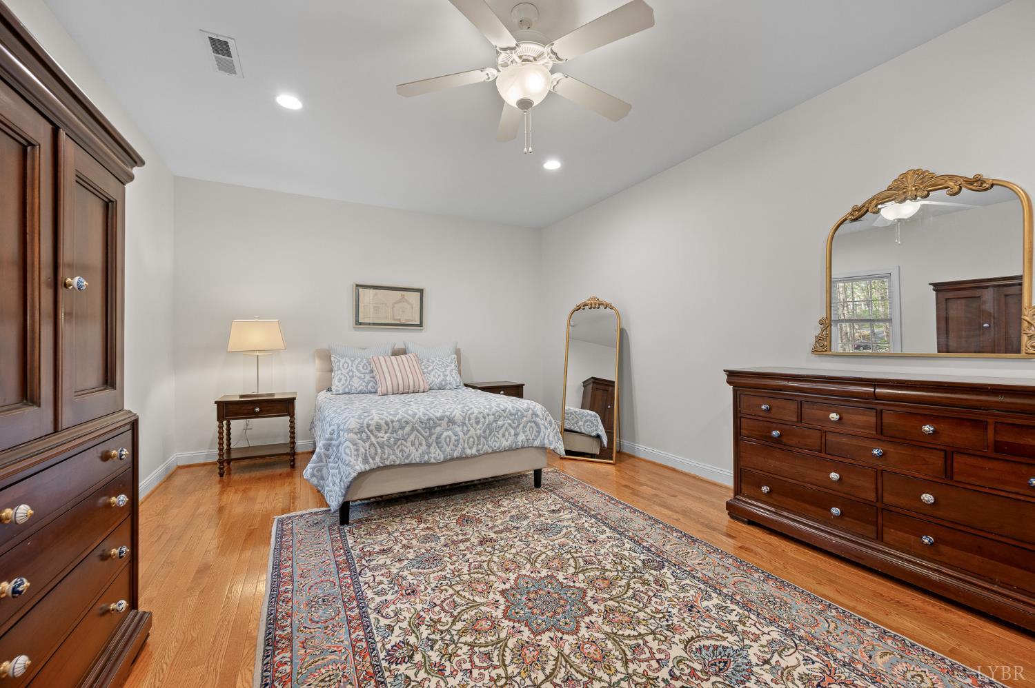 1089 Howards Scenic Trail Forest, VA 24551 - Photo 23 of 96 a bedroom with a bed and a dresser with mirror