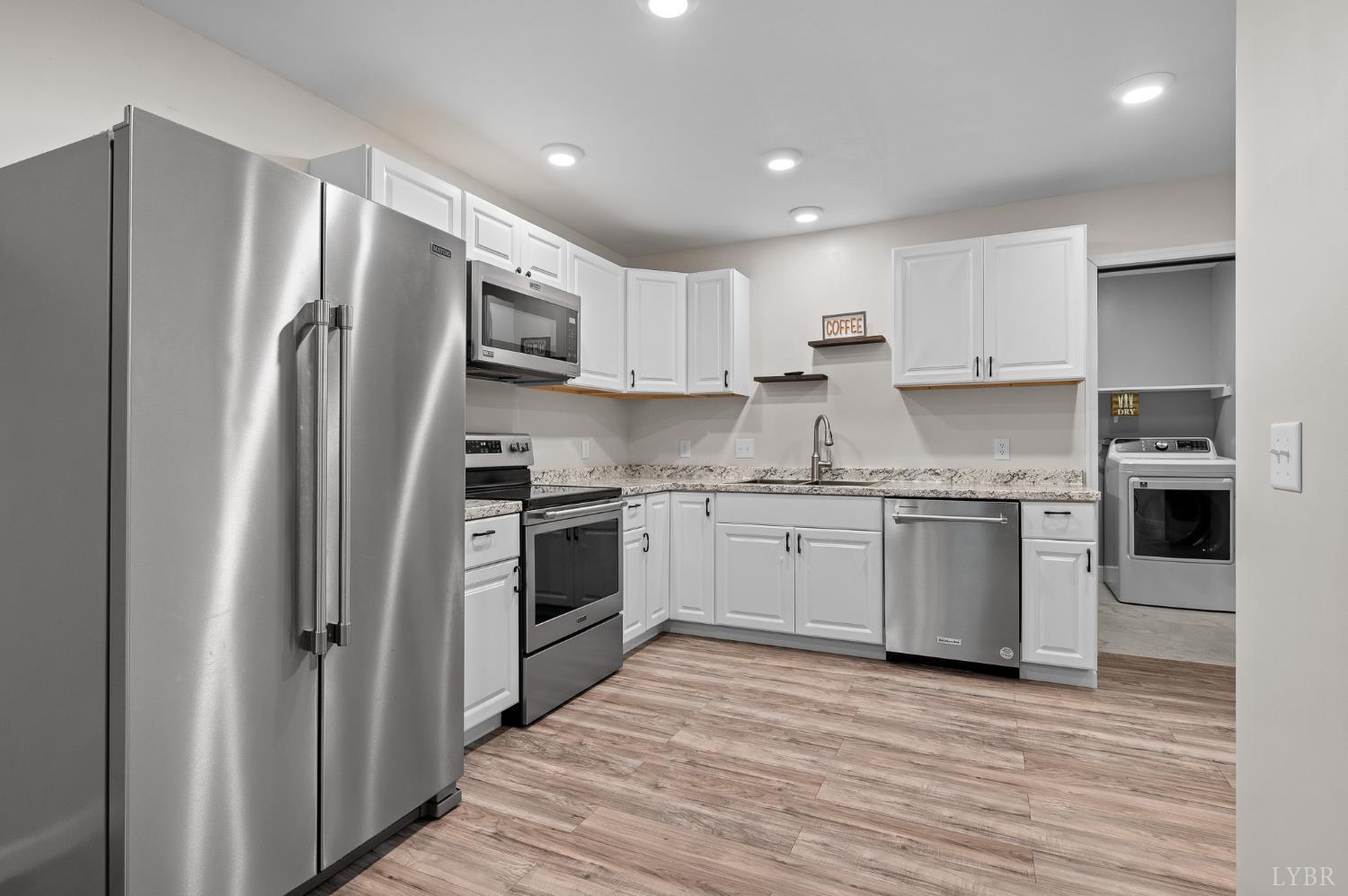 1089 Howards Scenic Trail Forest, VA 24551 - Photo 52 of 96 a kitchen with stainless steel appliances granite countertop a refrigerator and a stove top oven