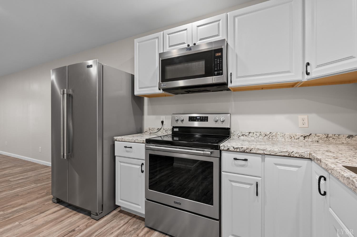 1089 Howards Scenic Trail Forest, VA 24551 - Photo 54 of 96 a kitchen with stainless steel appliances granite countertop a stove a microwave and a refrigerator