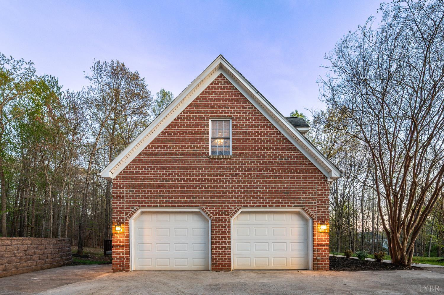1089 Howards Scenic Trail Forest, VA 24551 - Photo 83 of 96 a front view of house with garage and trees