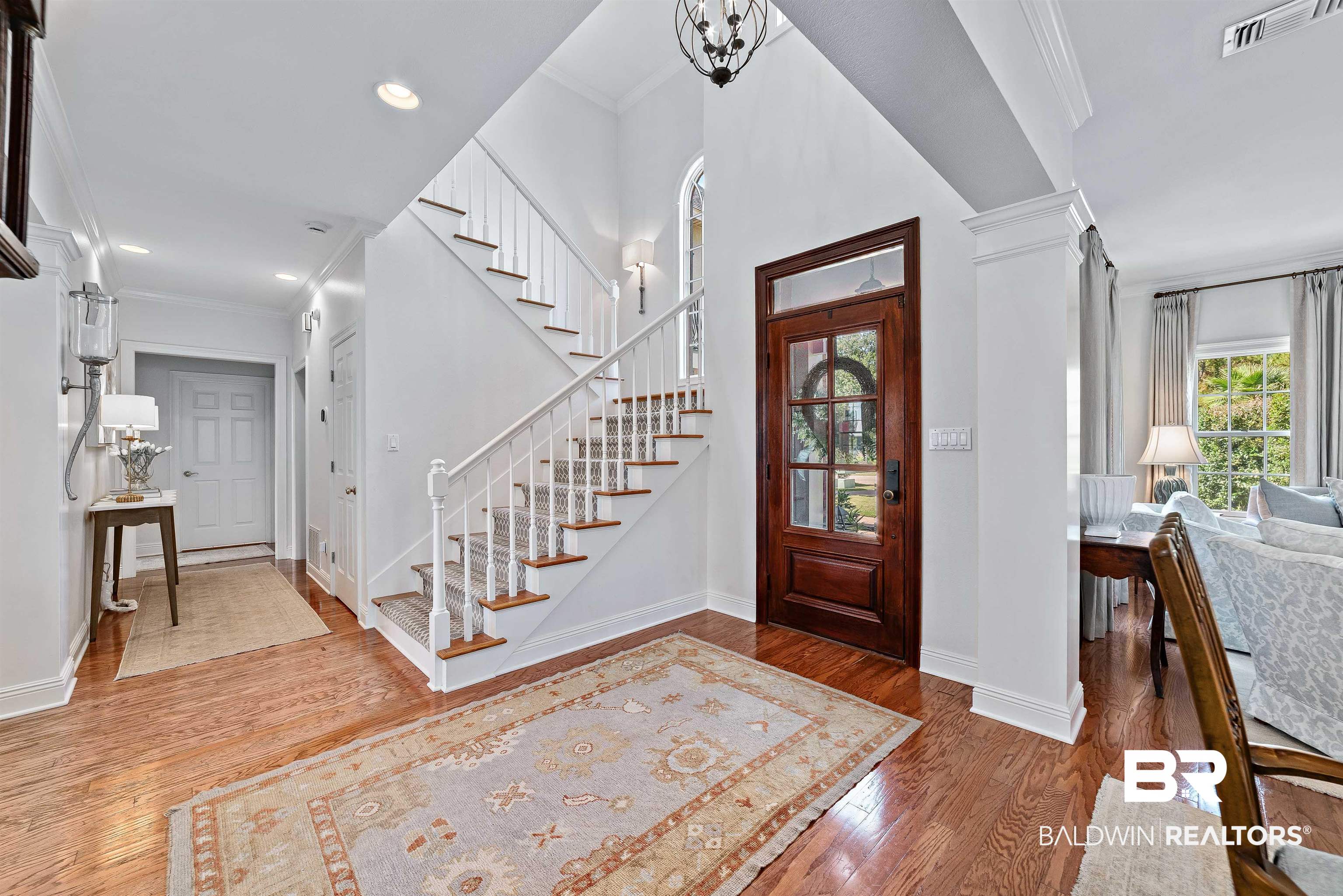 6630 East Quarry Drive Elberta, AL 36530 - Photo 17 of 63 Foyer featuring ornamental molding, wood finished floors, plenty of natural light, ornate columns, and stairway