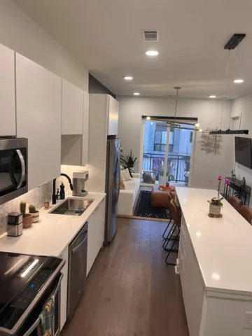 a kitchen with a sink stove and cabinets