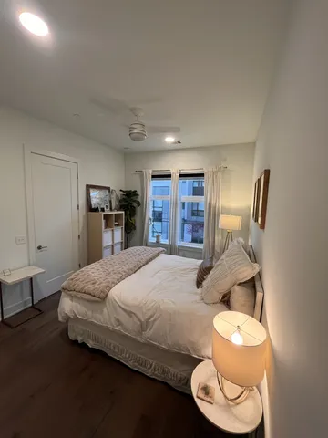 a bedroom with a bed and a large mirror