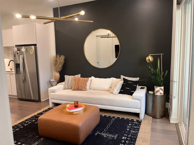 a living room with furniture and a mirror