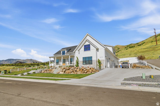 2013 South 100 West Perry, UT 84302 - Photo 6 of 49 Modern farmhouse style residence featuring white vertical siding, a black shingle roof, and dark-framed windows