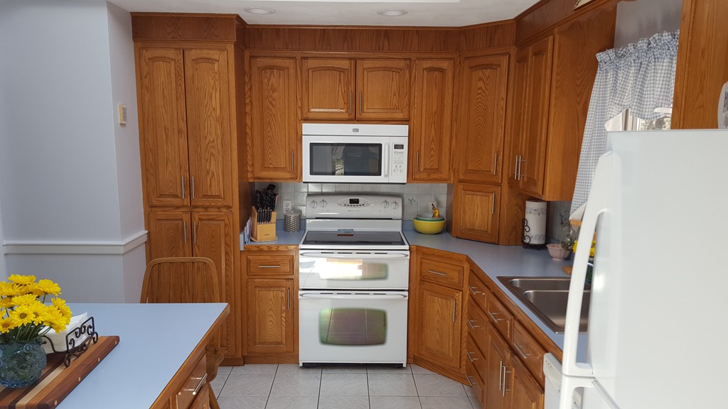 15 Stage Coach Road Boxford, MA 01921 - Photo 13 of 29 a kitchen with wooden cabinets and a stove top oven