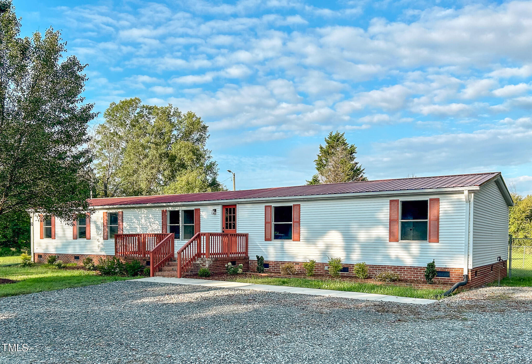 991 Country Club Road Roxboro, NC 27574 - Photo 1 of 11 a front view of a house with garden