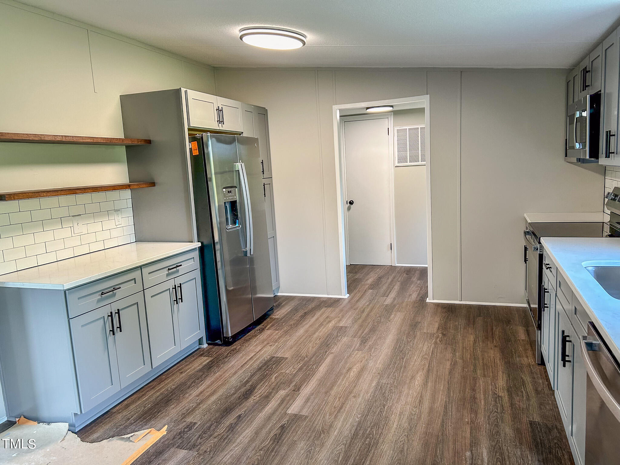 991 Country Club Road Roxboro, NC 27574 - Photo 5 of 11 a kitchen with granite countertop a refrigerator and a sink