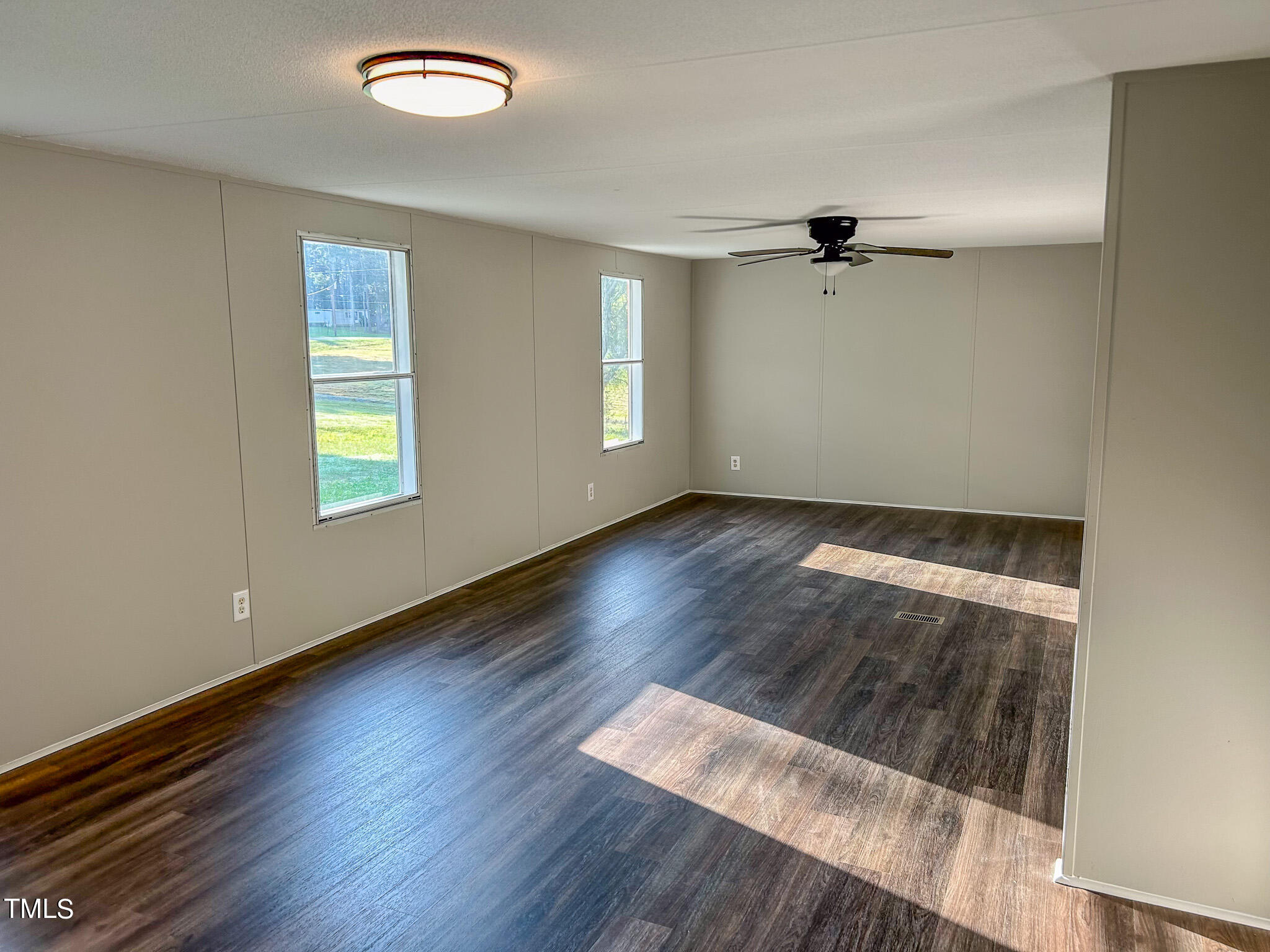 991 Country Club Road Roxboro, NC 27574 - Photo 6 of 11 an empty room with wooden floor cabinet and windows