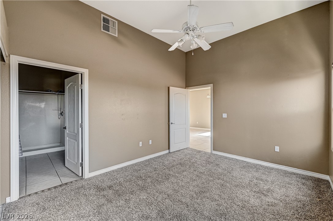 8985 South Durango Drive, Unit 2187 Las Vegas, NV 89113 - Photo 16 of 73 A comfortable bedroom featuring soft carpet and a convenient walk-in closet with ample storage.