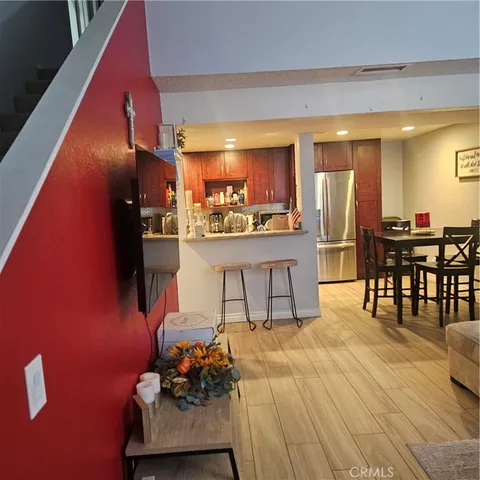 a living room with stainless steel appliances kitchen island granite countertop furniture and a large window