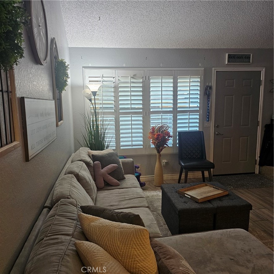435 West 9th, Unit B3 Upland, CA 91786 - Photo 11 of 71 a living room with furniture and a window