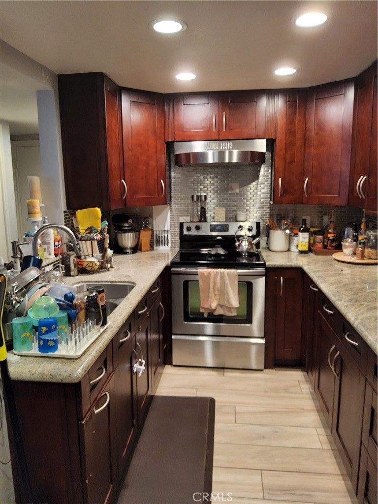 435 West 9th, Unit B3 Upland, CA 91786 - Photo 12 of 71 a kitchen with stainless steel appliances granite countertop a stove a sink and a microwave