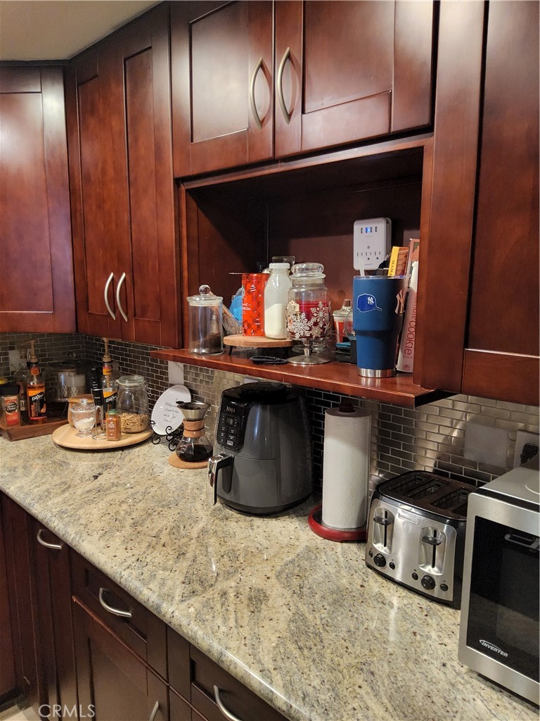 435 West 9th, Unit B3 Upland, CA 91786 - Photo 13 of 71 a kitchen with a sink and a stove with wooden floor
