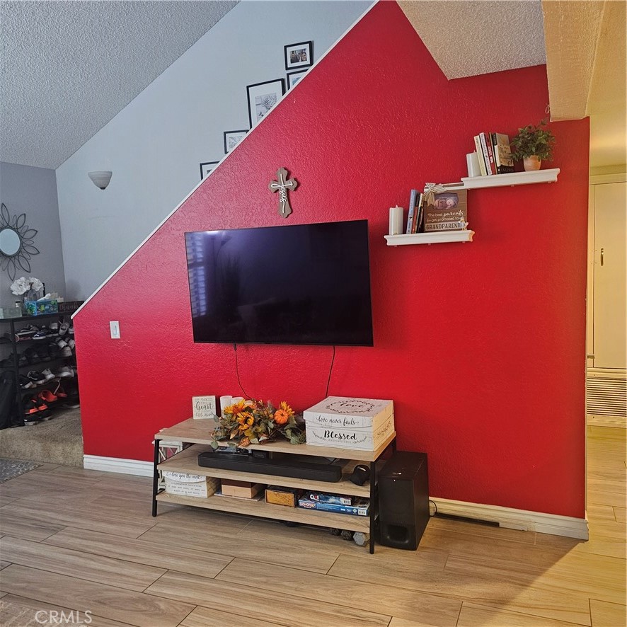 435 West 9th, Unit B3 Upland, CA 91786 - Photo 29 of 71 a view of a living room with furniture and a flat screen tv