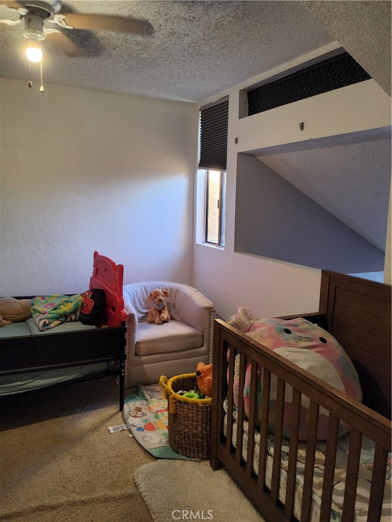 435 West 9th, Unit B3 Upland, CA 91786 - Photo 34 of 71 a bedroom with bed and a baby crib